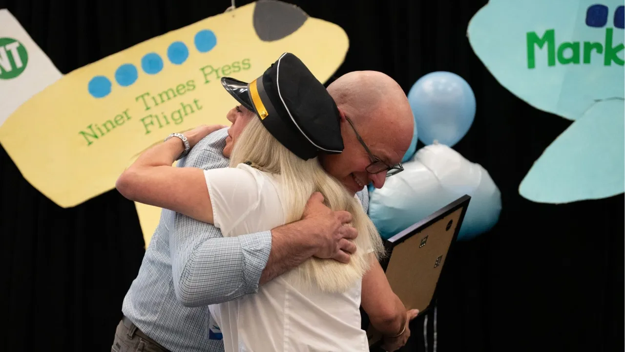 Kelly Merges congratulating Dr. Dan Grano