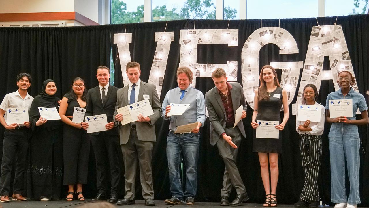 Uptown Audio staff members holding up certificates