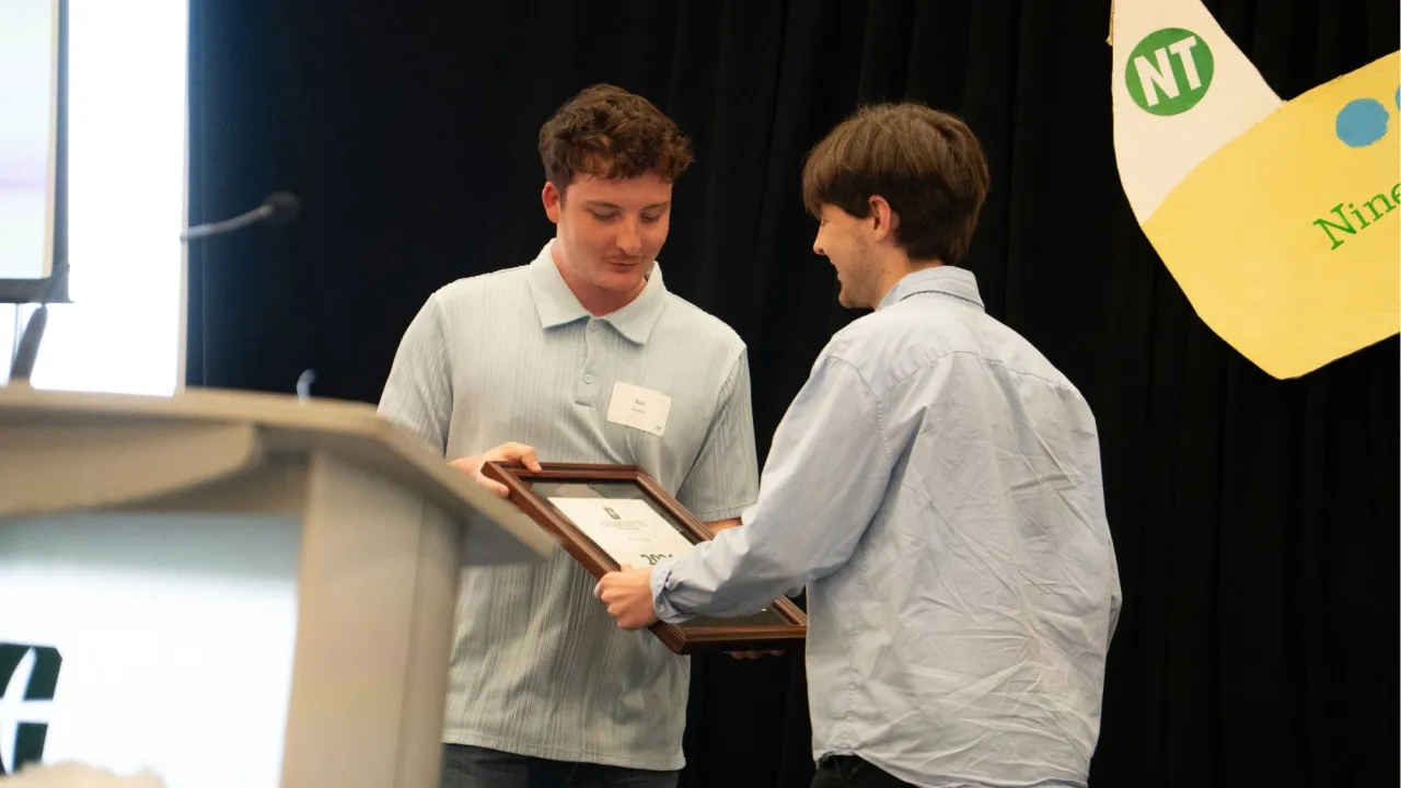 Ben Stadler receiving award from Zach Jenkins