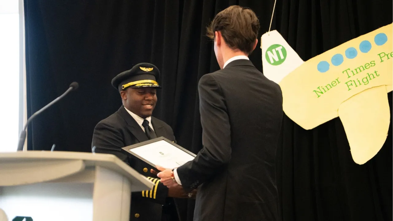 Emmanuel Perkins receiving award from Davis Cuffe