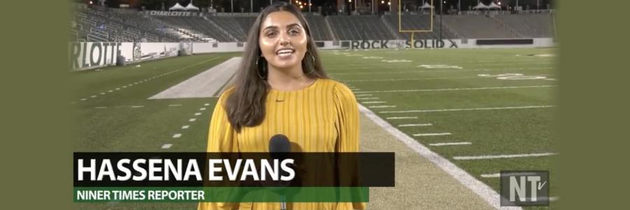 Broadcast journalist student standing on the football field reporting latest game